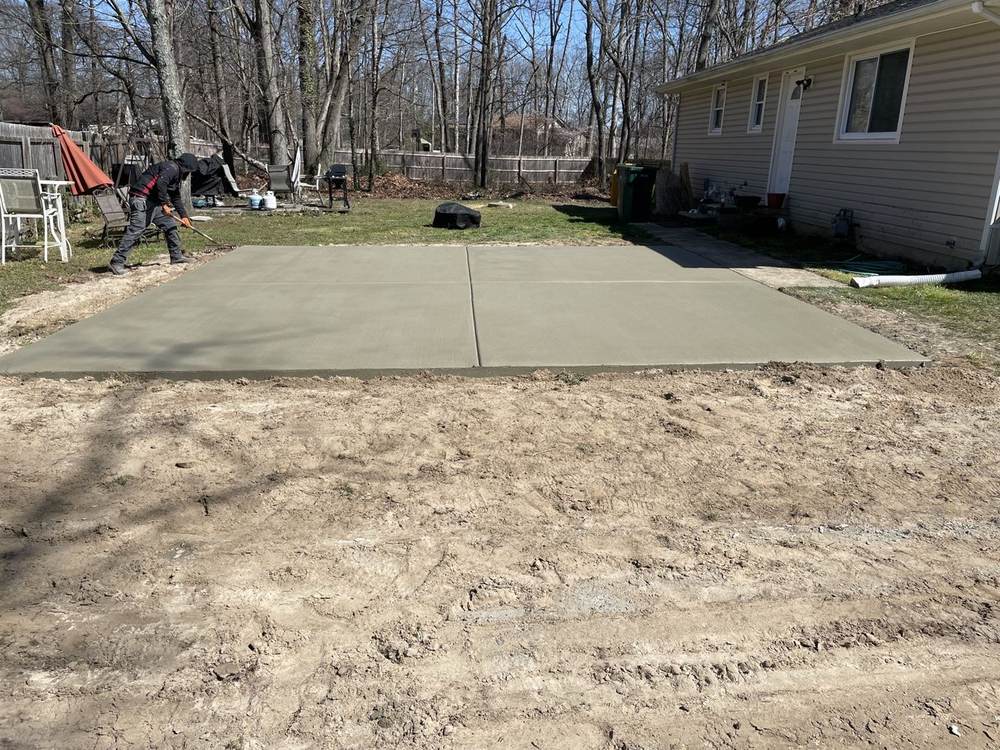 Concrete walkway with steps to a brick home entrance by South Jersey Construction Enterprise